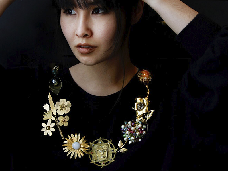 Ayna wearing a "necklace" of brooches from the TJL Collection, photo courtesy of The Jewelry Library